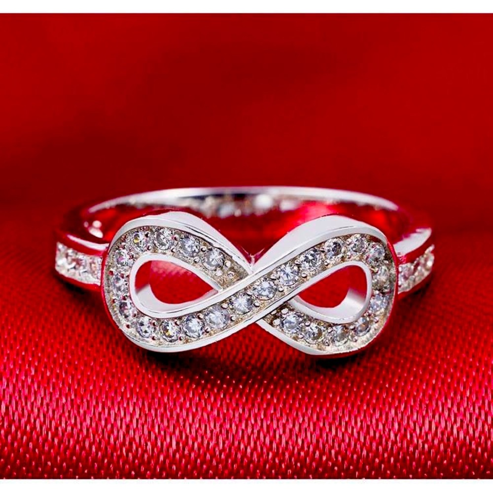 Silver in color marked with .925 symbol of infinity ring  band. NWT